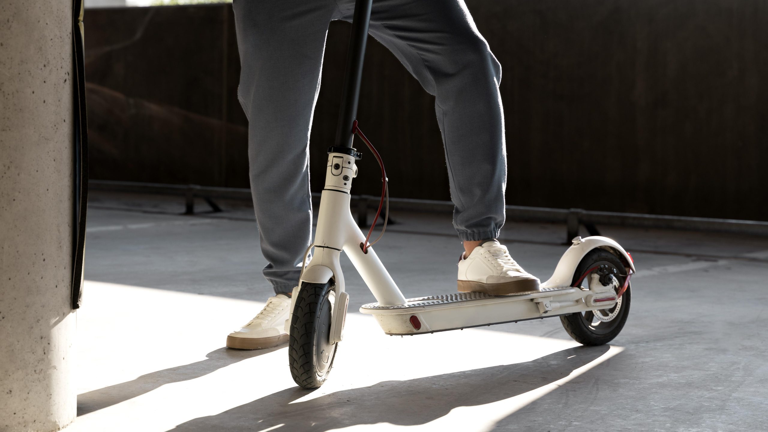 man with his scooter parking lot indoors