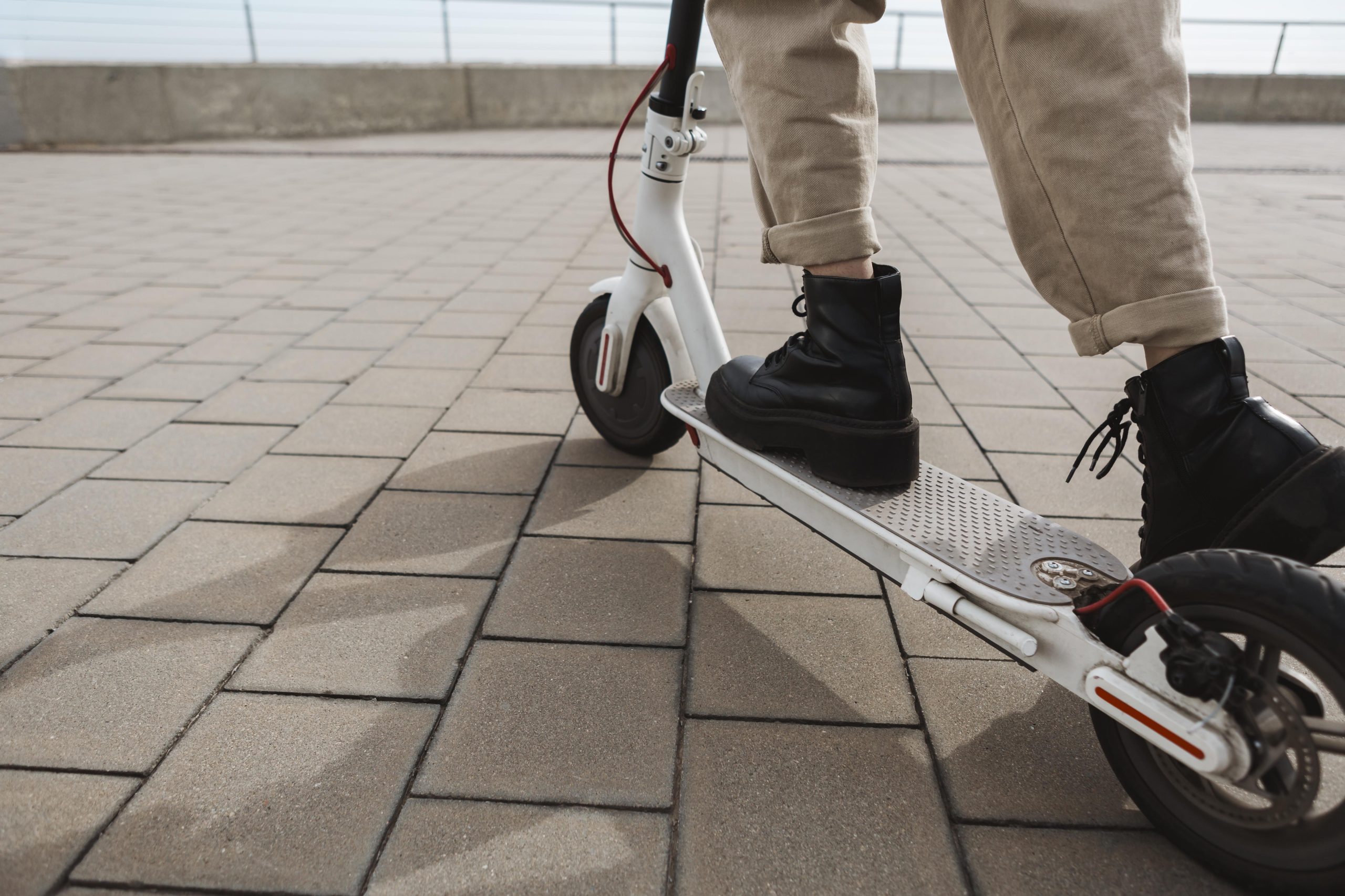 young woman riding electric scooter